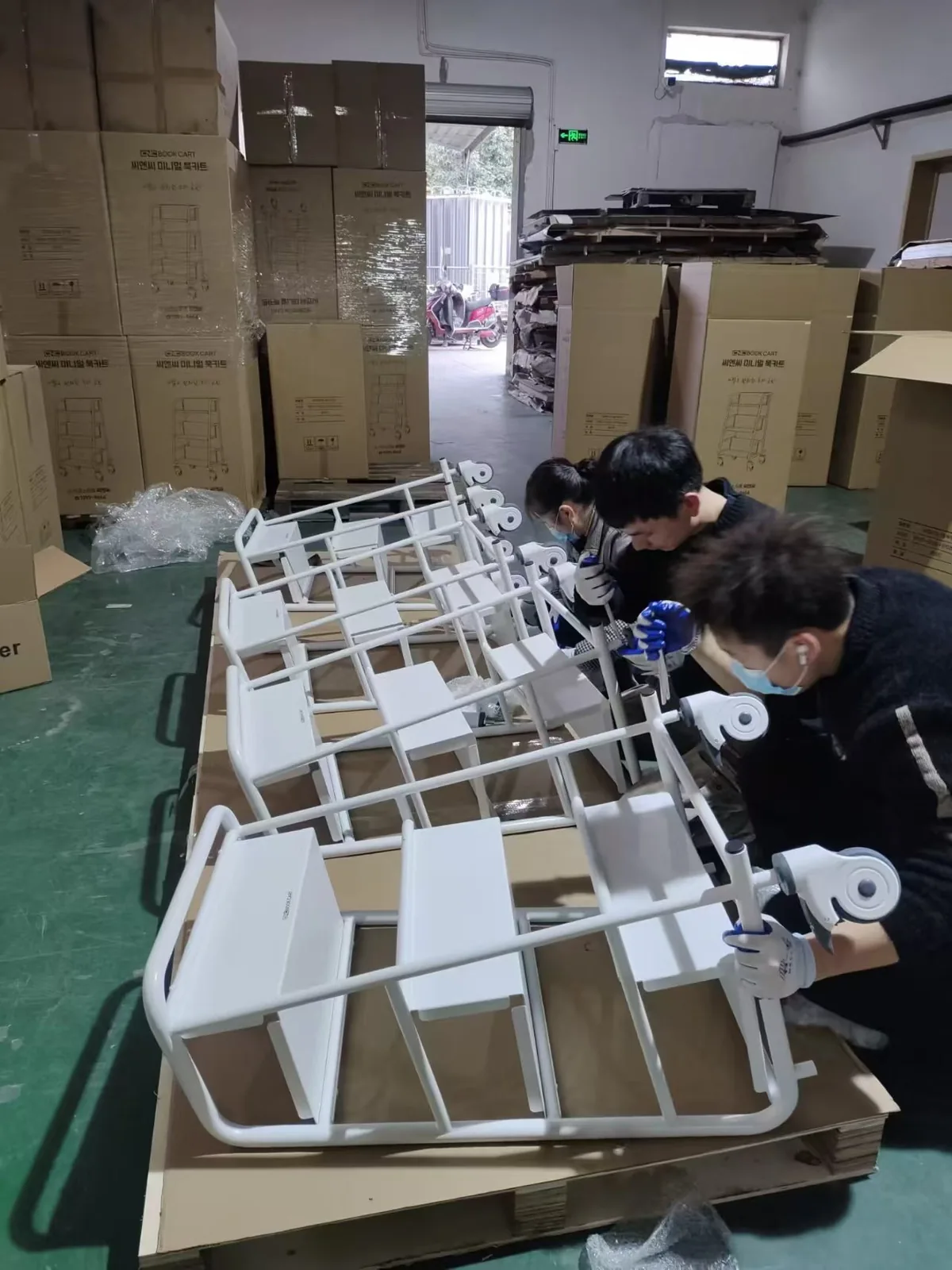 Assembly team working on trolley frames in the Ningbo workshop