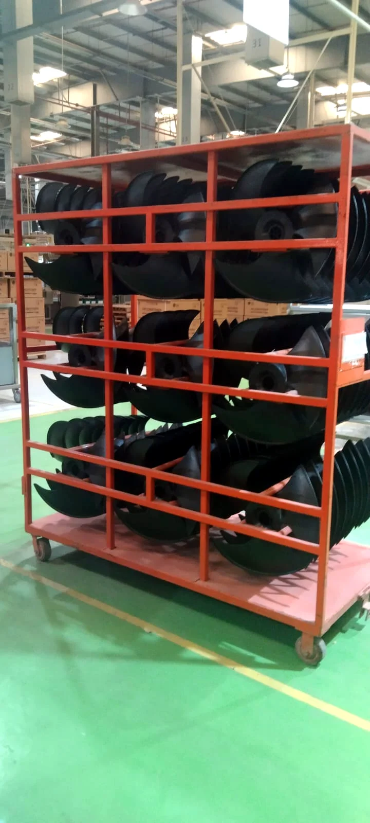 Welded transfer cart loaded with parts inside a factory
