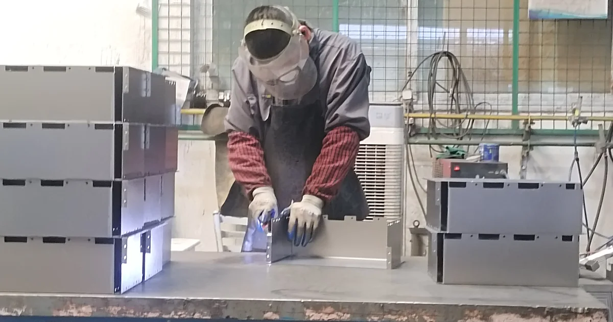 Welding trolley frames at a fixture station