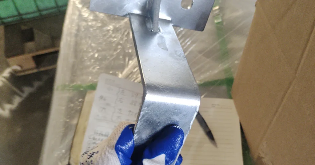 Galvanized steel bracket checked against a workshop drawing
