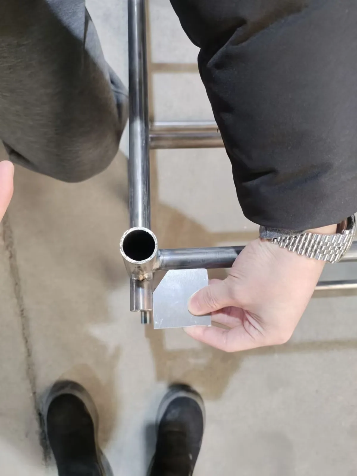 Inspector checking tube joint angle during trolley assembly