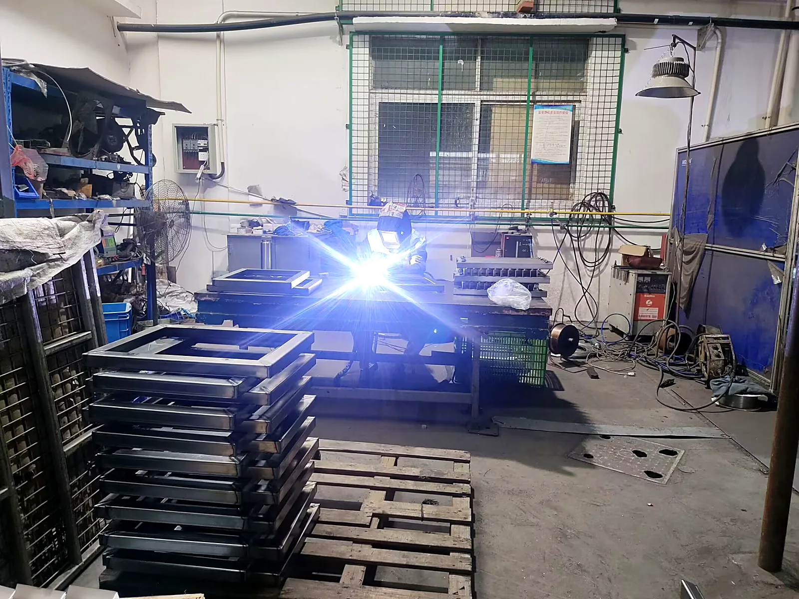 Welding steel tube trolley frames in a jig at our factory